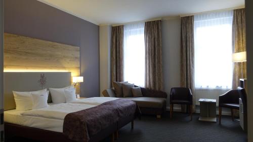Ein Bett oder Betten in einem Zimmer der Unterkunft Höger's Hotel & Restaurant