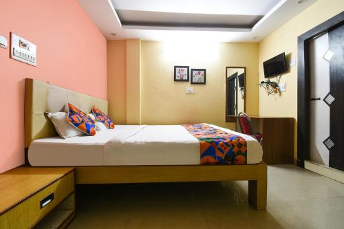 a bedroom with a bed and a television in it at FabHotel DP International in Patna