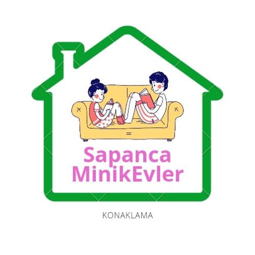 two people sitting on a couch in a house at SAPANCA MİNİK EVLER in Sapanca