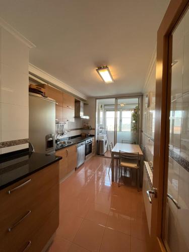 a kitchen with a table and a dining room at Salinas al Mar in Salinas