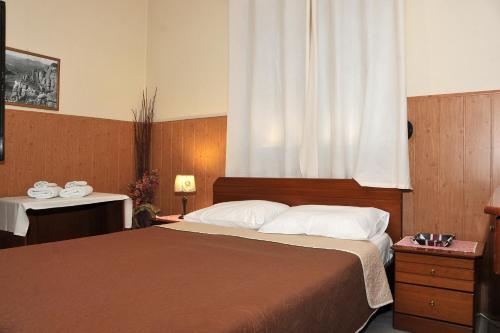 um quarto com uma cama grande e uma janela em GUESTHOUSE BLOUTSOS ROOMS em Kastrákion