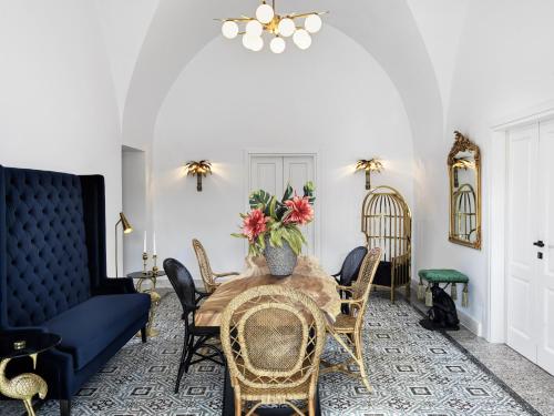 a dining room with a table and chairs at La Maltese Estate in Imerovigli