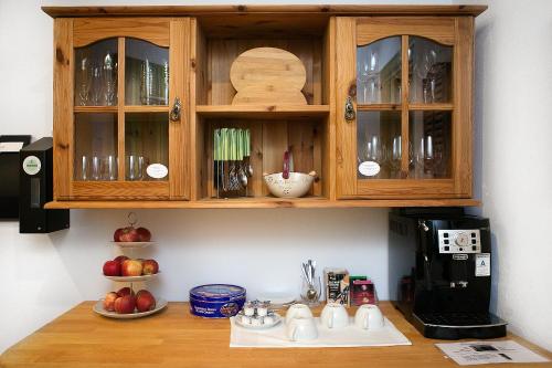 a kitchen with wooden cabinets and a coffee maker at Landgasthof Rebstock in Sulzburg