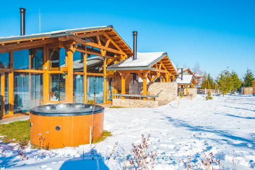 a building with a barrel in front of it in the snow at Mountain Hawk Park in Bansko