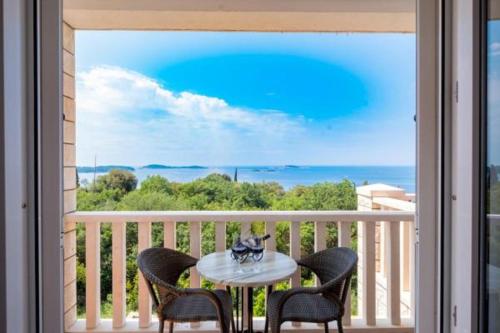 ein Tisch auf einem Balkon mit Blick auf das Meer in der Unterkunft Villa Panorama Dubrovnik in Mlini
