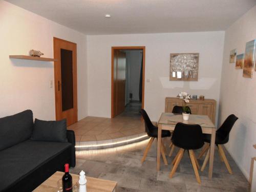 a living room with a couch and a table at Gartenhaus Diana - 120 m zum Strand in Bansin