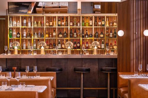 a bar with a lot of bottles of wine at One Hundred Shoreditch in London