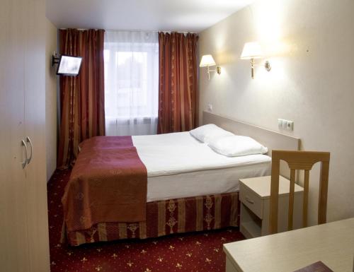 Ένα ή περισσότερα κρεβάτια σε δωμάτιο στο AMAKS Russia Hotel