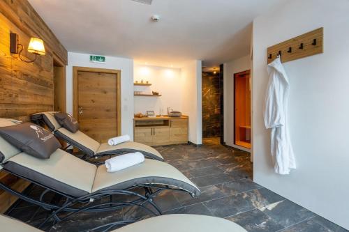 a room with three barber chairs and a sink at Schönachhof in Gerlos