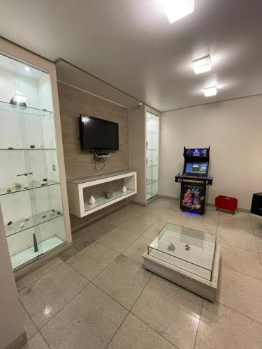 a living room with a flat screen tv on a wall at Hotel Beira Rio in Teófilo Otoni