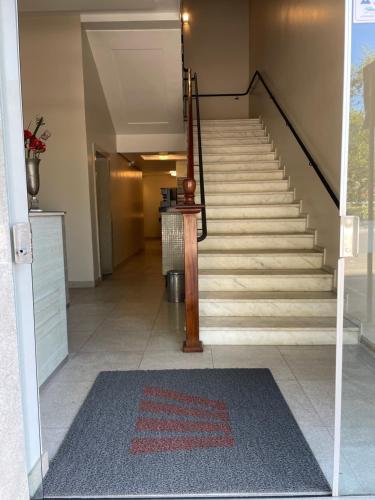 a staircase in a house with a rug on the floor at Hotel Beira Rio in Teófilo Otoni