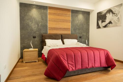 ein Schlafzimmer mit einem großen Bett mit einer roten Decke in der Unterkunft Eutuxia in Taranto