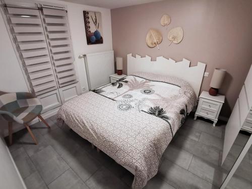 a bedroom with a bed and a chair in it at Agréable logis au calme avec jardin entre PARIS et EURODISNEY in Rosny-sous-Bois