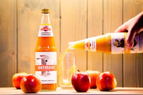 a bottle of apple juice next to apples on a table at fjord hotel berlin in Berlin