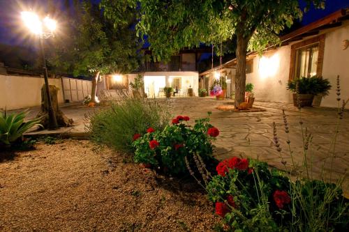 a courtyard at night with flowers and a street light at Casa Vacanze Borgo Borghese in SantʼAlessio Siculo