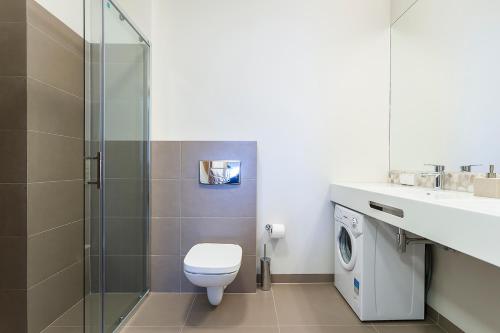 a bathroom with a toilet and a sink and a shower at Wczasowa, Sun & Snow in Ustka
