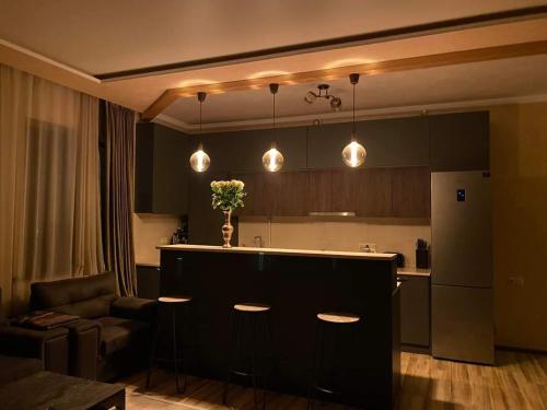 a kitchen with a bar and a living room at Guest House VELVET in Tsaghkadzor