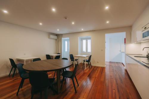 a kitchen and dining room with a table and chairs at Azores Inn - Family Suites in Ponta Delgada