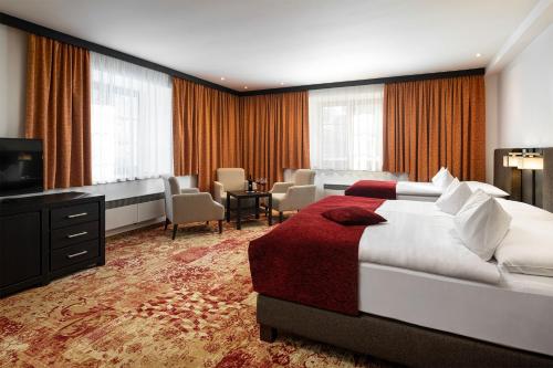 a hotel room with a bed and a living room at Hotel Singer in Ludvíkov