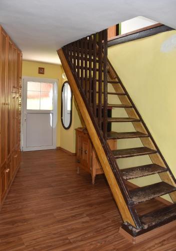 a wooden staircase in a room with a door at Chalupa Mája in Hřensko
