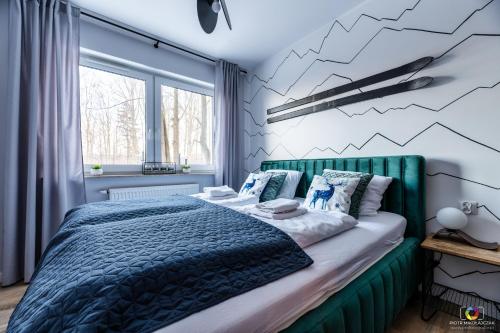 Posteľ alebo postele v izbe v ubytovaní Apartament U Nas w Sudetach