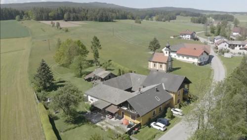 an aerial view of a large house in a field at Familienapartments mit Balkon oder Terrasse und Garten in Ober-Lembach