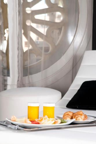two glasses of beer and a plate of food at Hospes Palacio de los Patos, a Member of Design Hotels in Granada