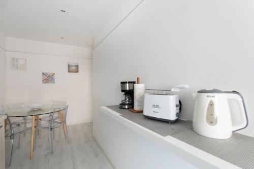 a kitchen counter with a coffee maker and a table at Canaletto Apartment Rialto in Venice