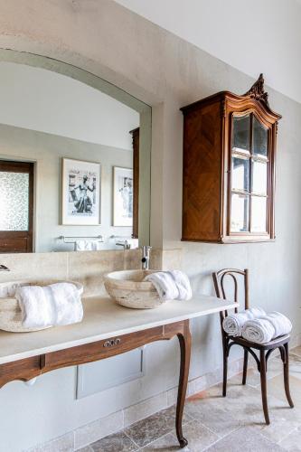 a bathroom with a sink and a mirror at Domaine Rabiega - Vineyard and Boutique hotel in Draguignan