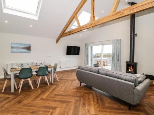 a living room with a couch and a table and chairs at Y Bwthyn in Amlwch