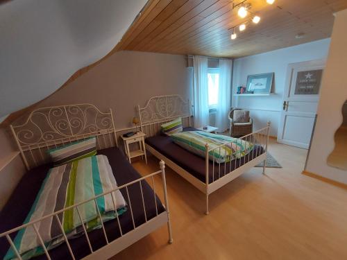 a bedroom with two bunk beds and a staircase at Ferienwohnung am Lieserpfad in Nerdlen