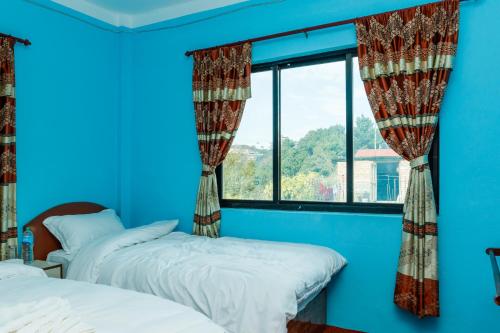 Posteľ alebo postele v izbe v ubytovaní Nagarkot Nayagaun Homestay