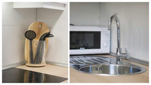 a kitchen counter with a sink and a microwave at Apartamento Pasaje del Barco by Toledo AP in Toledo