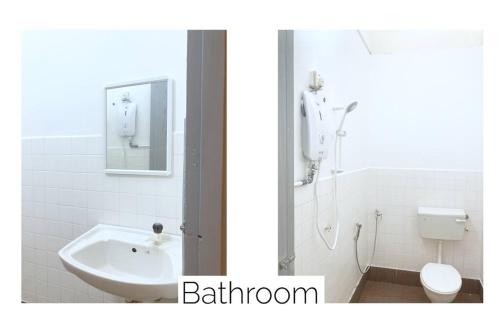 a white bathroom with a sink and a toilet at The Pigeon Alor Akar Guest House in Kuantan