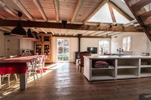 a kitchen and dining room with a table and chairs at Farmhouse 'het Plakje' in Bemmel