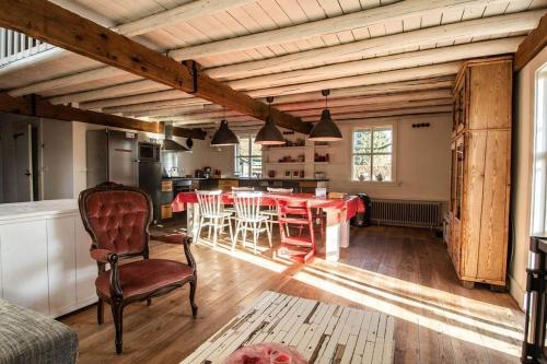 a kitchen and dining room with a table and chairs at Farmhouse 'het Plakje' in Bemmel