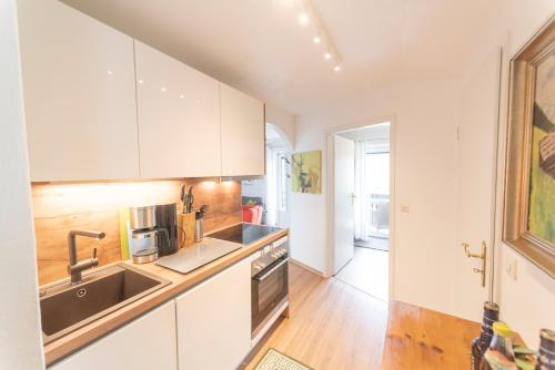 a kitchen with white cabinets and a sink at Zinsers Bergliebe in Inzell