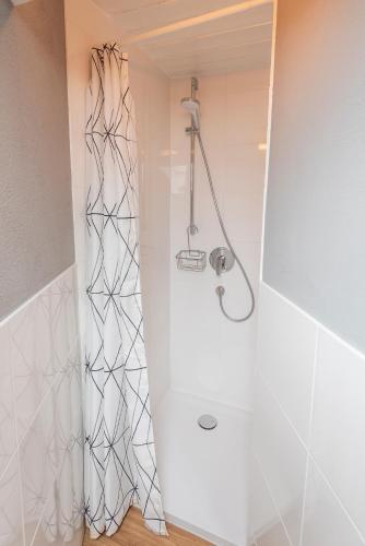 a shower with a glass door in a bathroom at Zinsers Bergliebe in Inzell