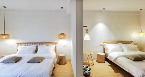 two beds in a room next to each other at Riverside Retreat Hotel in Yangshuo