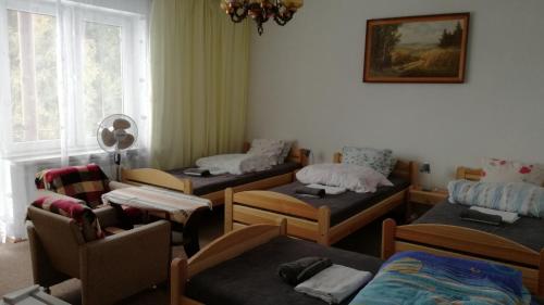 a room with four beds and a window at Agroturystyka u Mańka in Suwałki