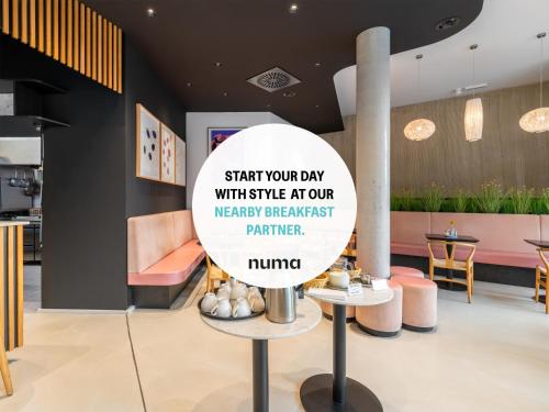 a sign in the lobby of a restaurant at Numa Berlin Drift in Berlin