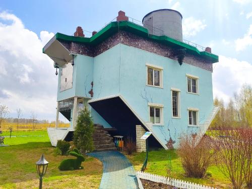 a large blue building with a ramp leading up to it at Night in Upsidedown House in Petrovo
