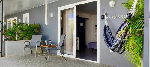 a table and chairs in front of a building at Studios 11and11Aruba in Palm-Eagle Beach