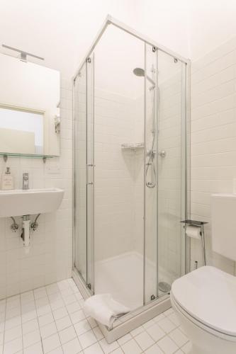 a bathroom with a shower and a toilet and a sink at Canaletto Apartments in Venice