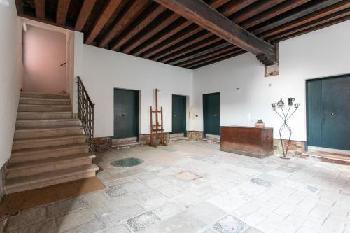 a large room with a staircase and a wooden ceiling at Canaletto Apartments in Venice