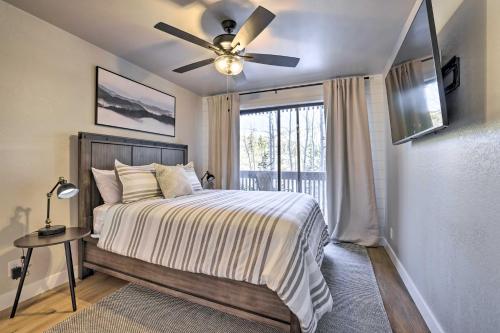 a bedroom with a bed with a ceiling fan and a window at Brian Head Condo Near Lifts at Giant Steps! in Brian Head
