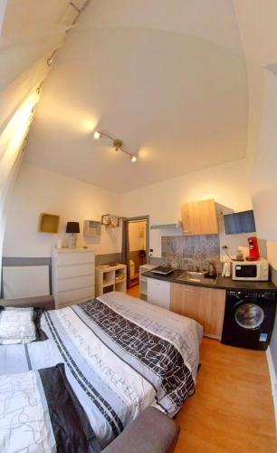 Habitación pequeña con cama y cocina en Petit studio Limoges gambetta, en Limoges