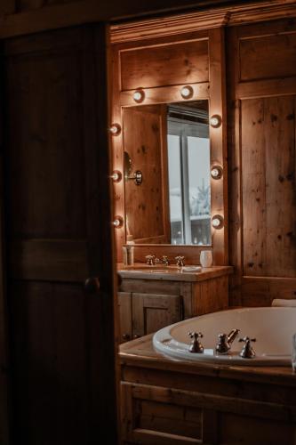 a bathroom with a sink and a mirror at Hotel Mont Blanc Megève in Megève