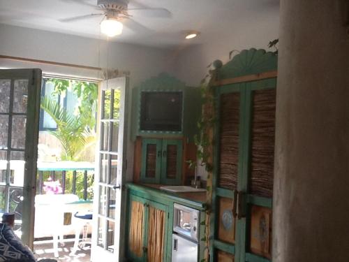 a kitchen with green cabinets and an open door at Les Artistes Inn in San Diego