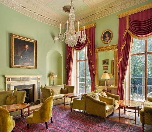 a living room filled with furniture and a chandelier at Home House - Private Member's Club in London